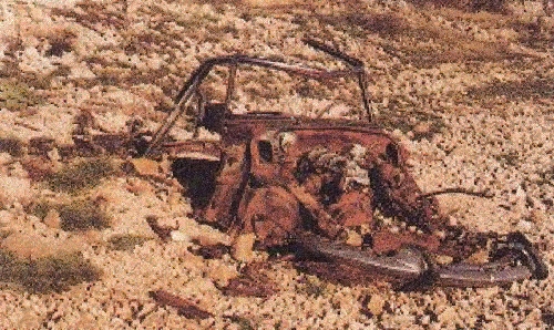 rusted D hulk in desert